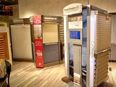 Store interior showcasing several different types of window coverings