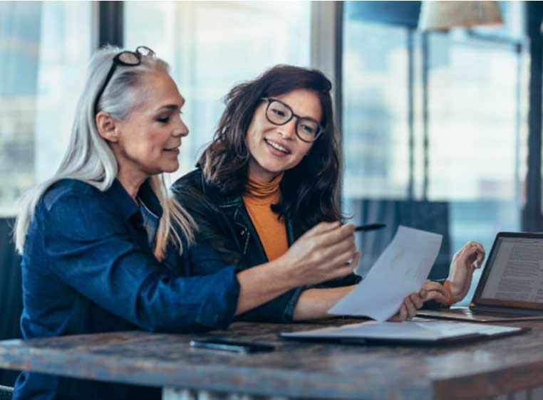 Two woman working at a desk
